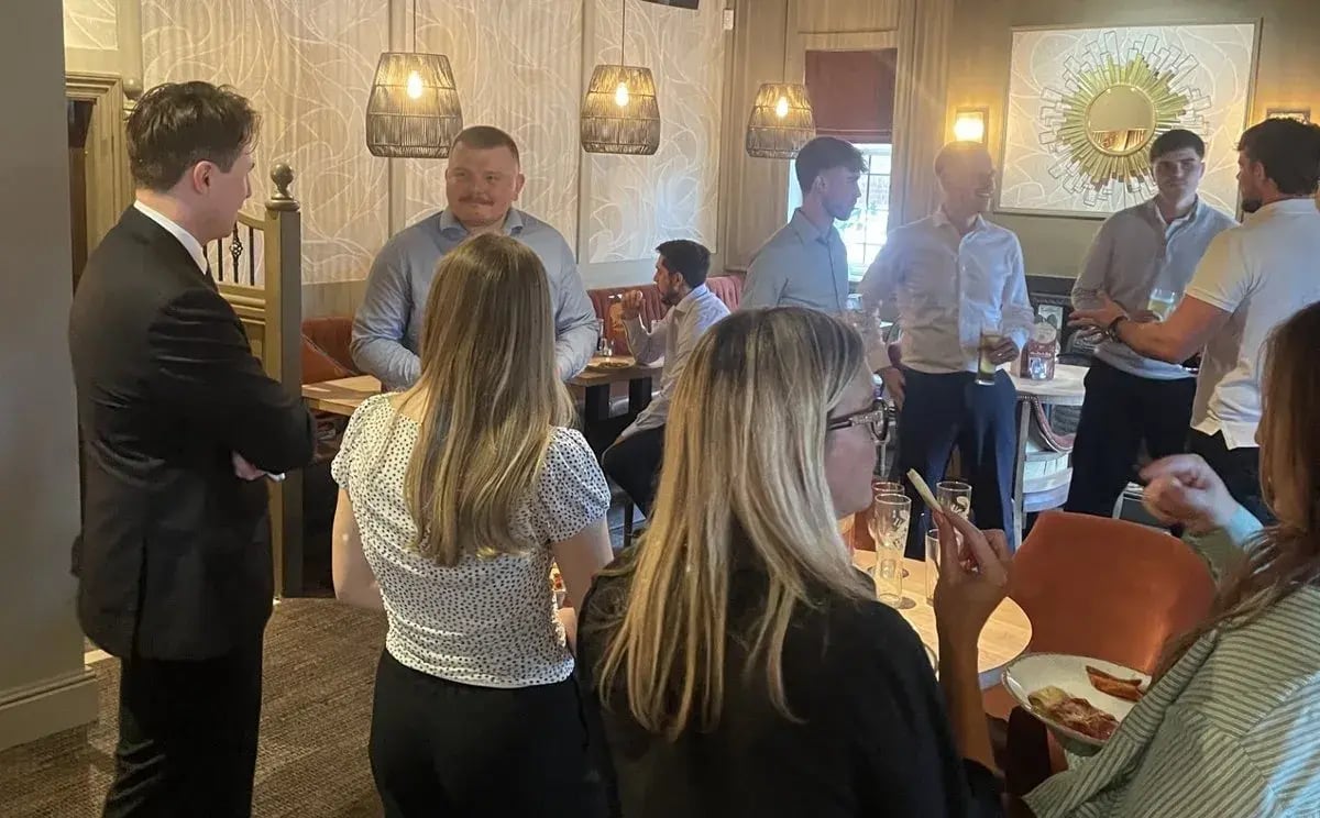 Guests talking in small groups at the September 5:05
