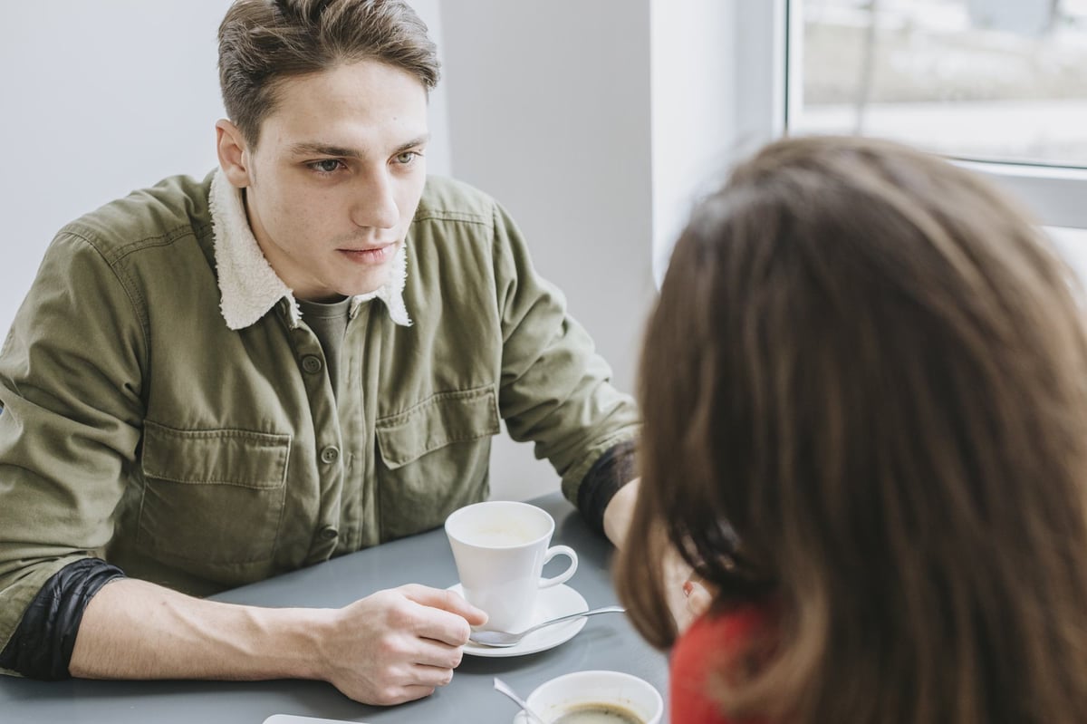A man and a woman talking calmly across a table